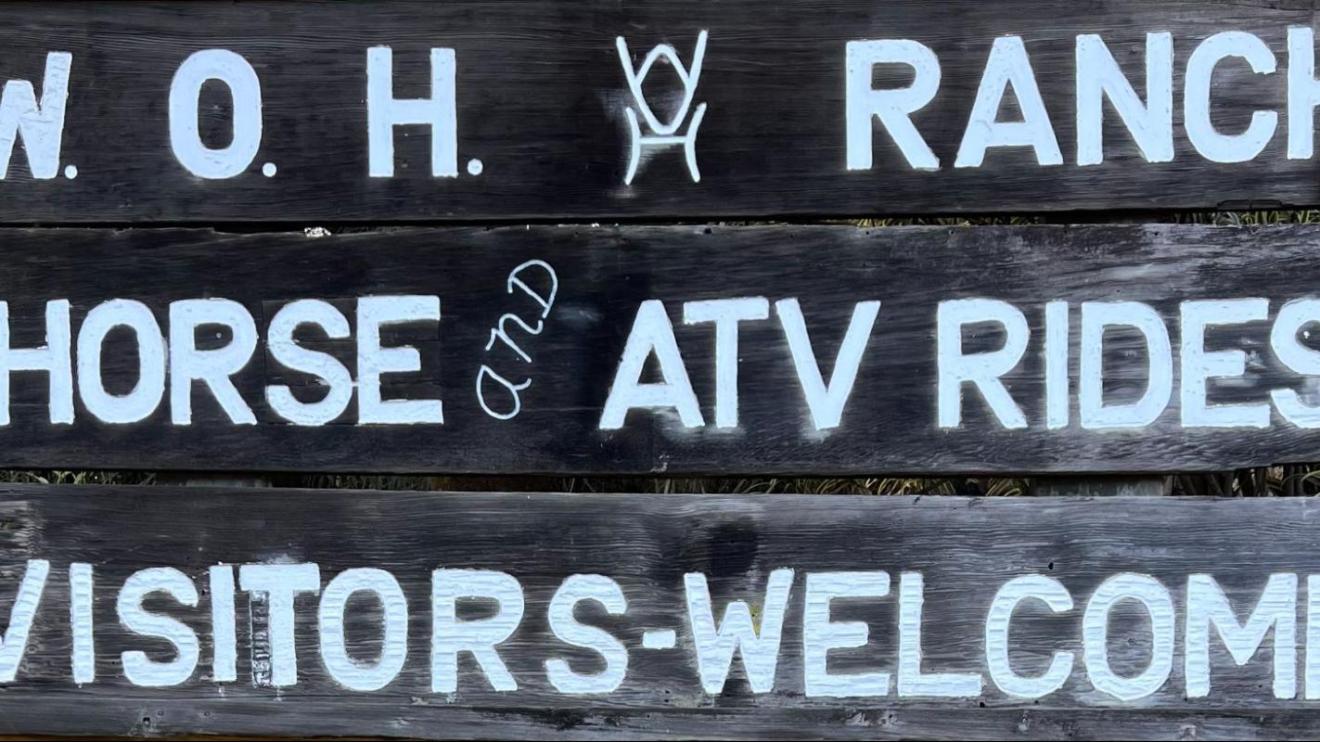 Wooden sign reads: W.O.H Ranch. Horse and ATV rides. Visitors welcome.